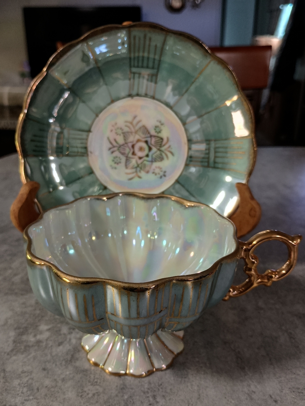 Elegant Aqua Iridescent Porcelain Teacup and Saucer with Gold Trim